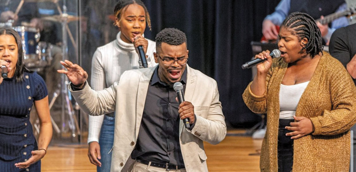 Gospel singers performing with microphones
