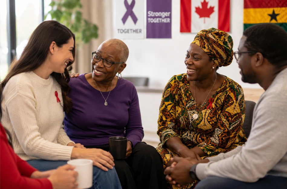 People sharing a conversation beside a cancer awareness banner
